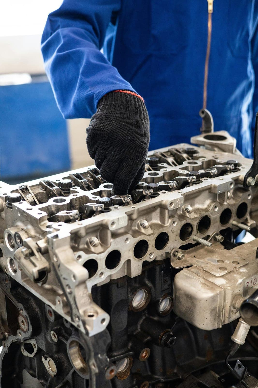 Mechanic inspecting an engine for signs of head gasket failure