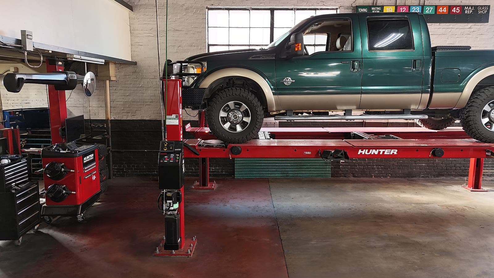 Hunter wheel-alignment rack in the Downtown Augusta shop with a Ford Super Duty pickup ready for service.