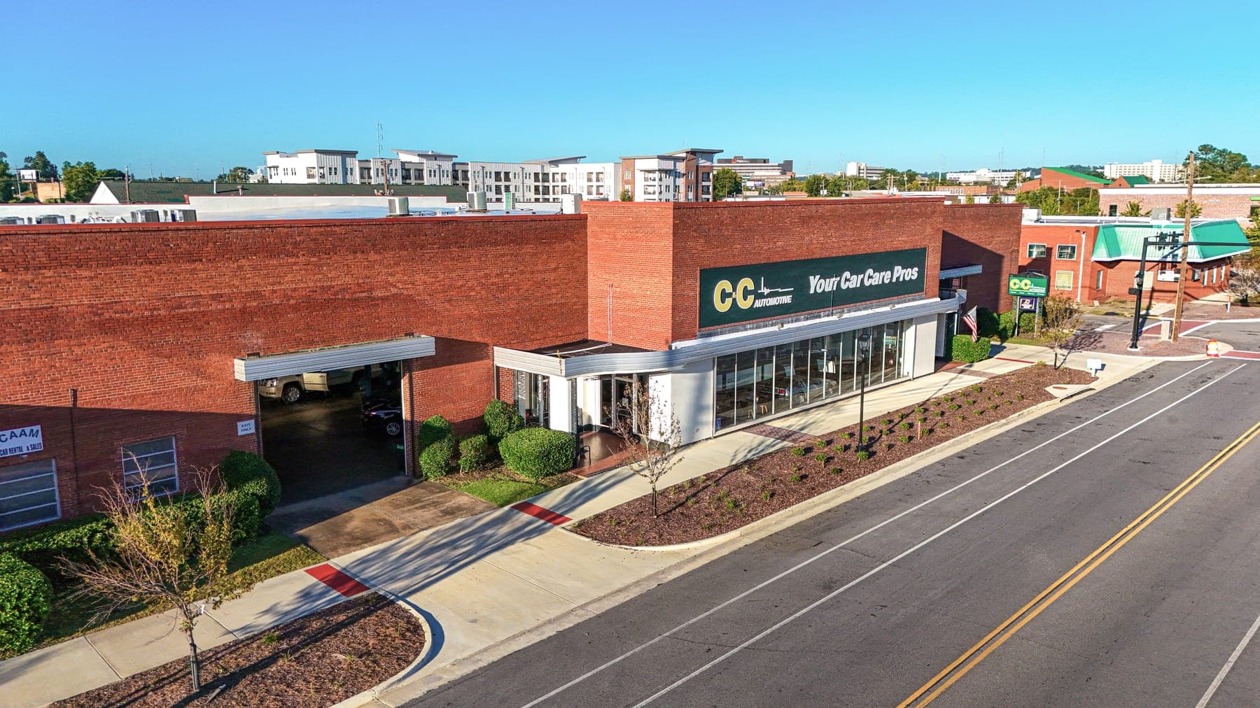 Aerial view of the C&C Automotive Downtown Augusta shop at 990 Telfair Street, with the Your Car Care Pros sign over the glass showroom.